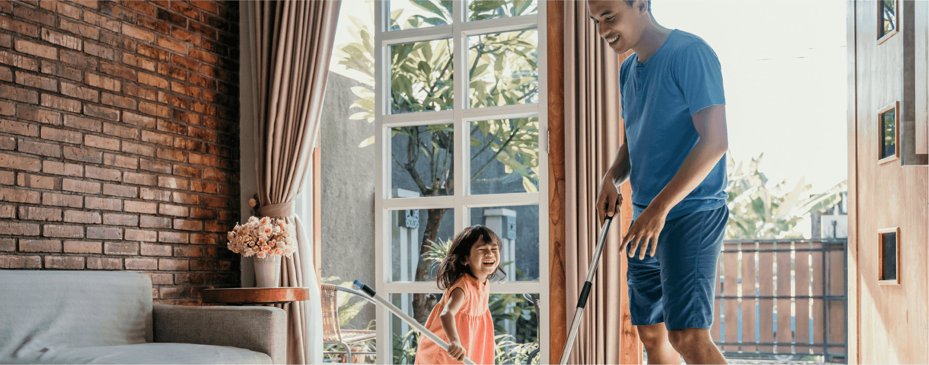 father and daughter cleaning living room together