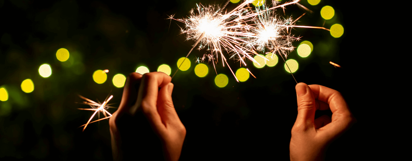 homeowner playing with sparklers near their home in the evening