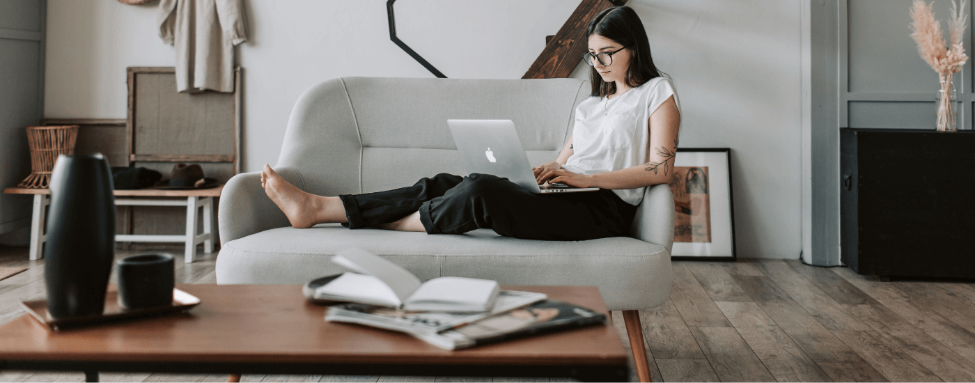 homeowner researching insurance costs on laptop while sitting on their couch