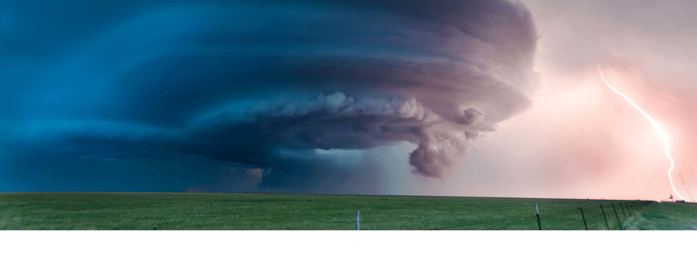 Tornado and a storm over a grassy field