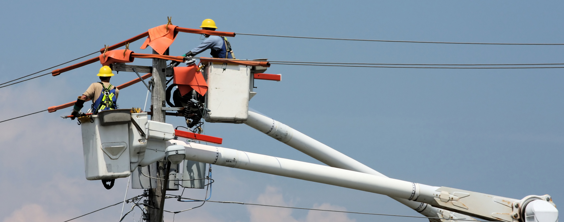 Two men repair a service line.