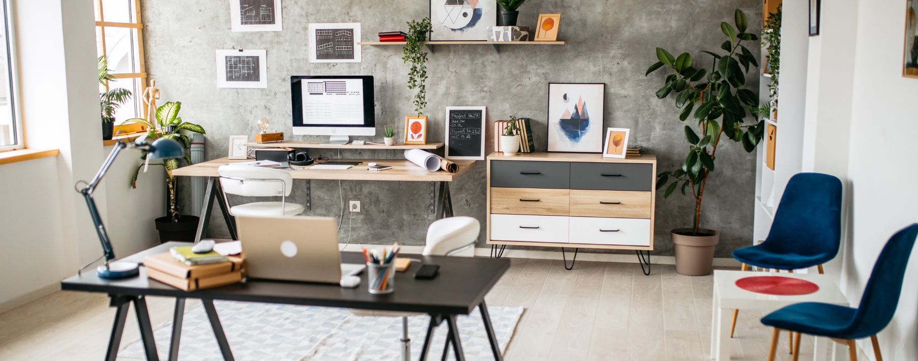 An light colored office with two desks with computers on them