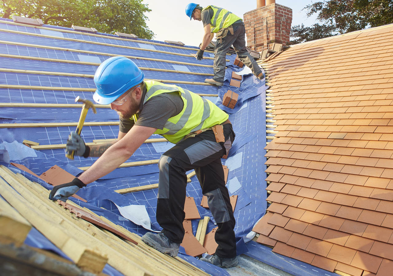 man working on roof with blue construction helmet