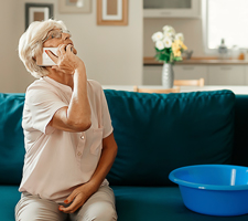 older woman with a leak in the ceiling