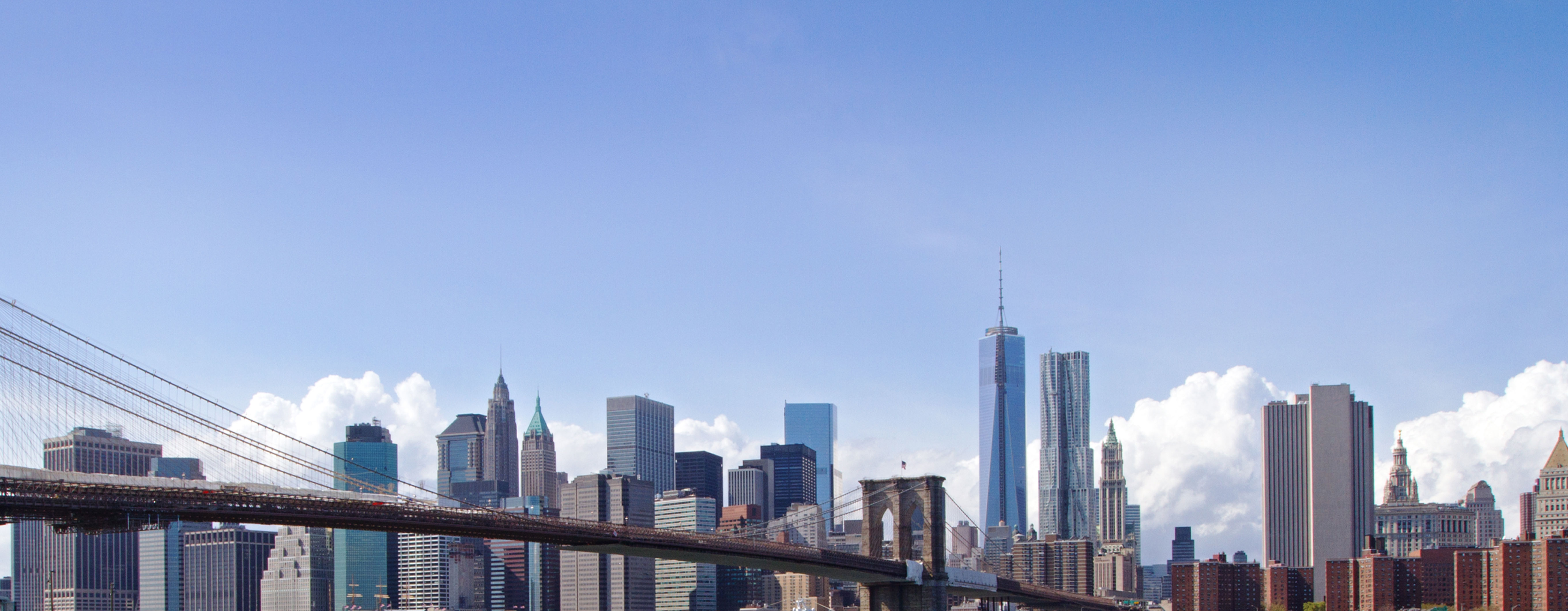 Image of buildings in New York City with a bridge