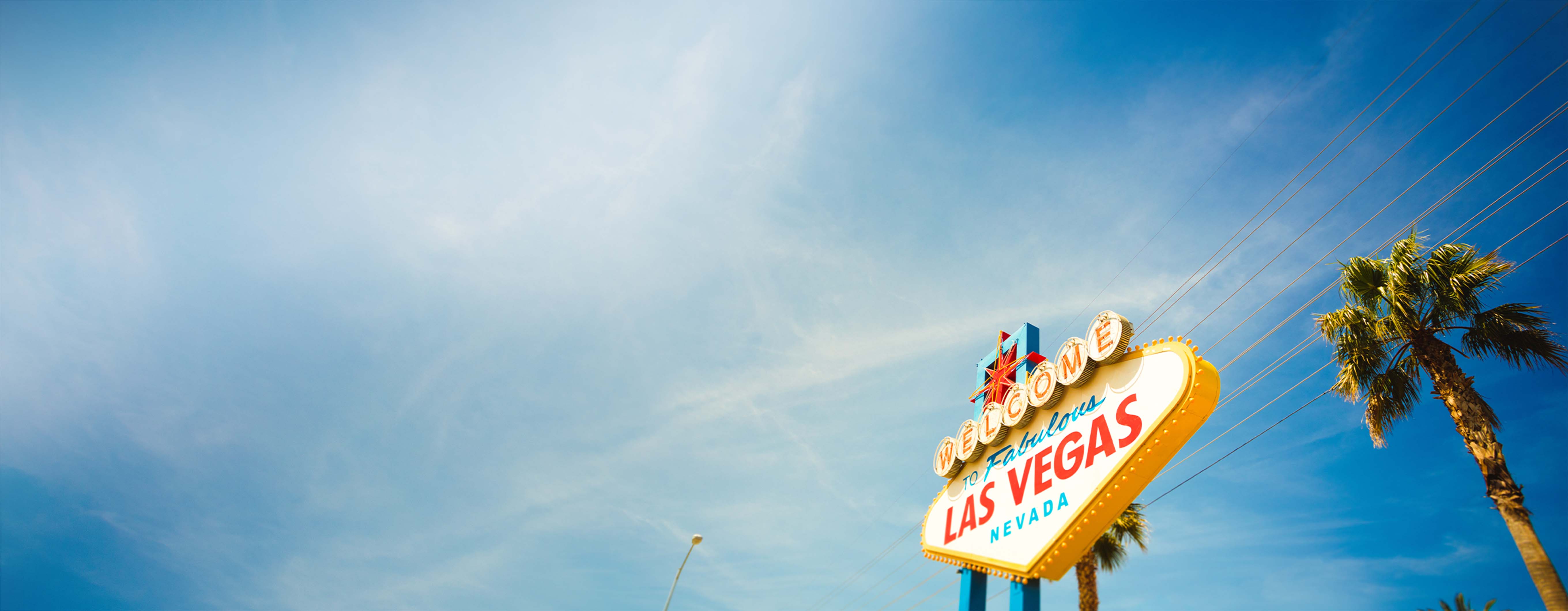 Image of a las vegas sign with a blue sky behind it