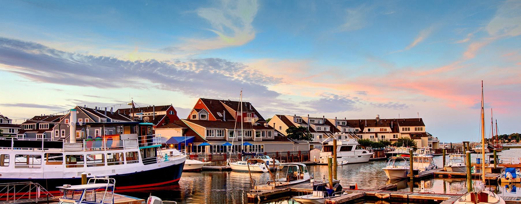 Image of a marina with plenty of boats and buildings around