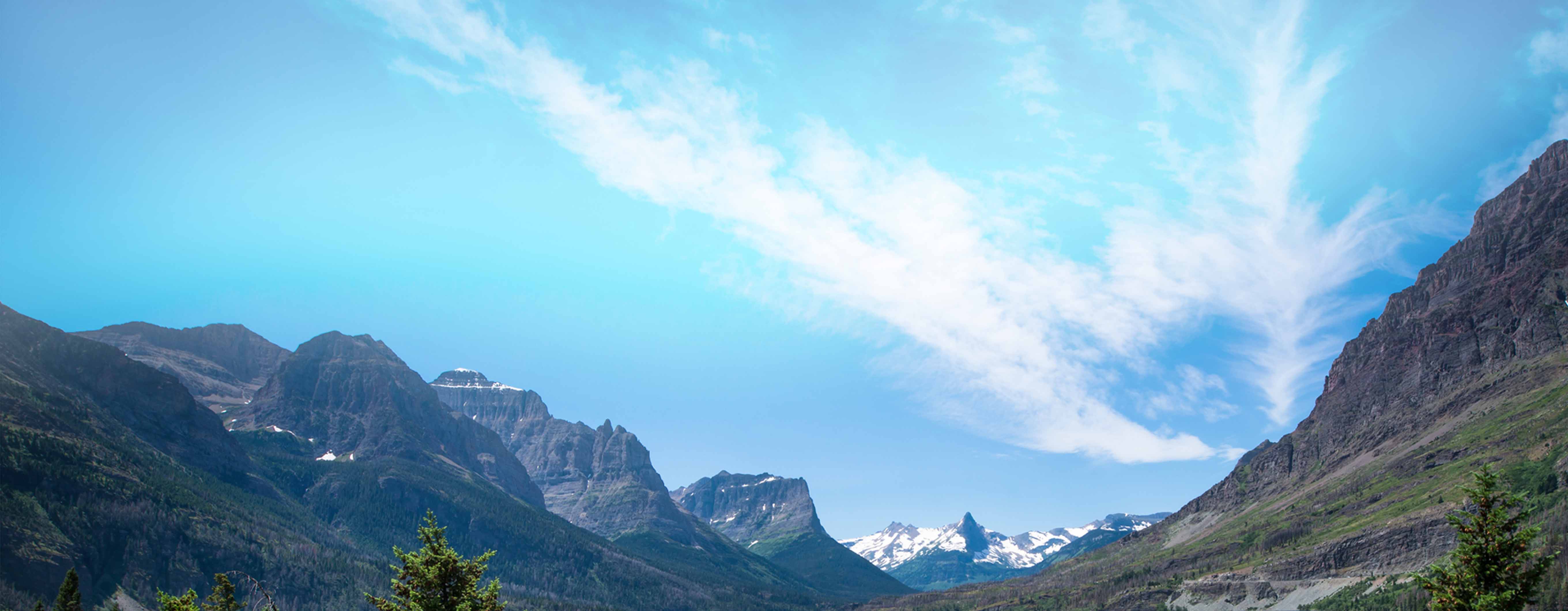 Image of a lake surrounded by mountains and trees