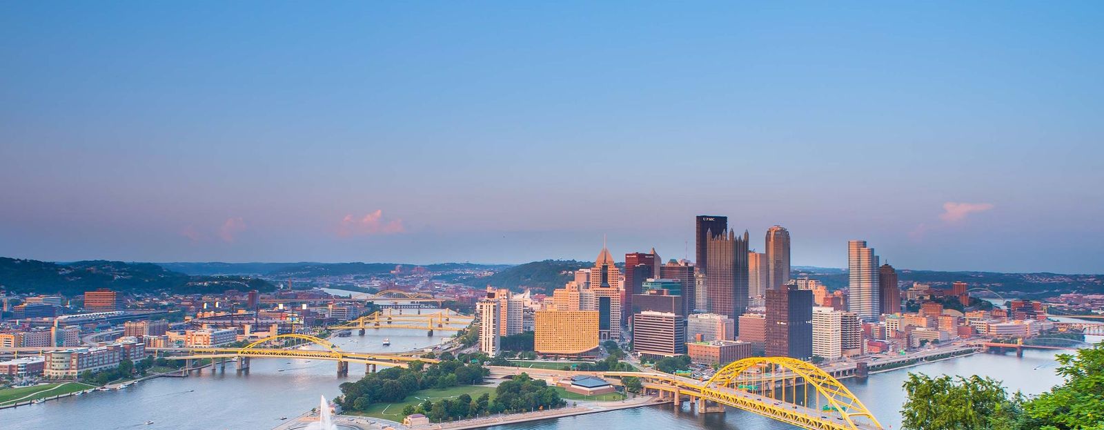 Image of buildings by bodies of water with yellow bridges