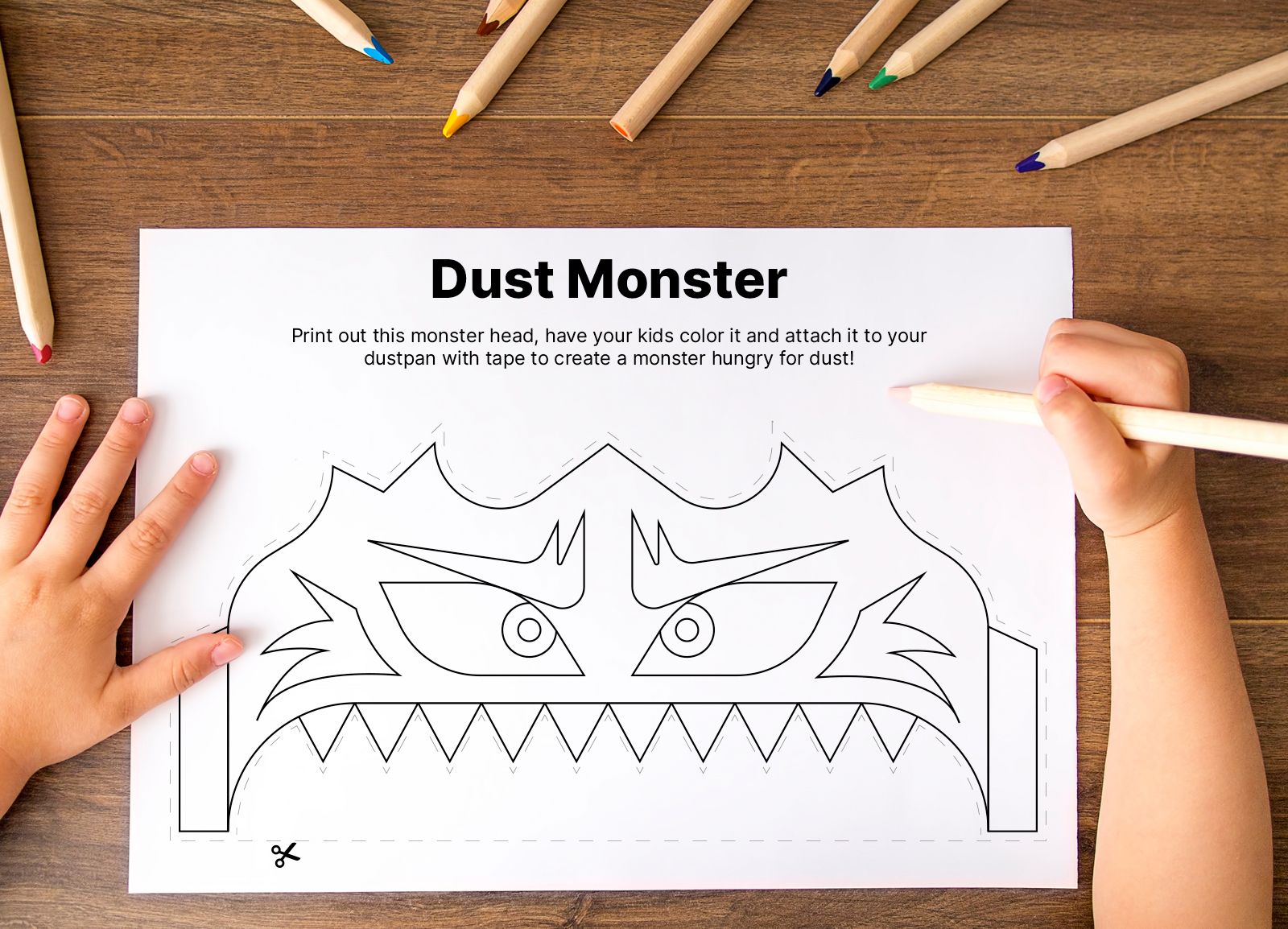 A child's hands prepare to color in a monster on a piece of paper.