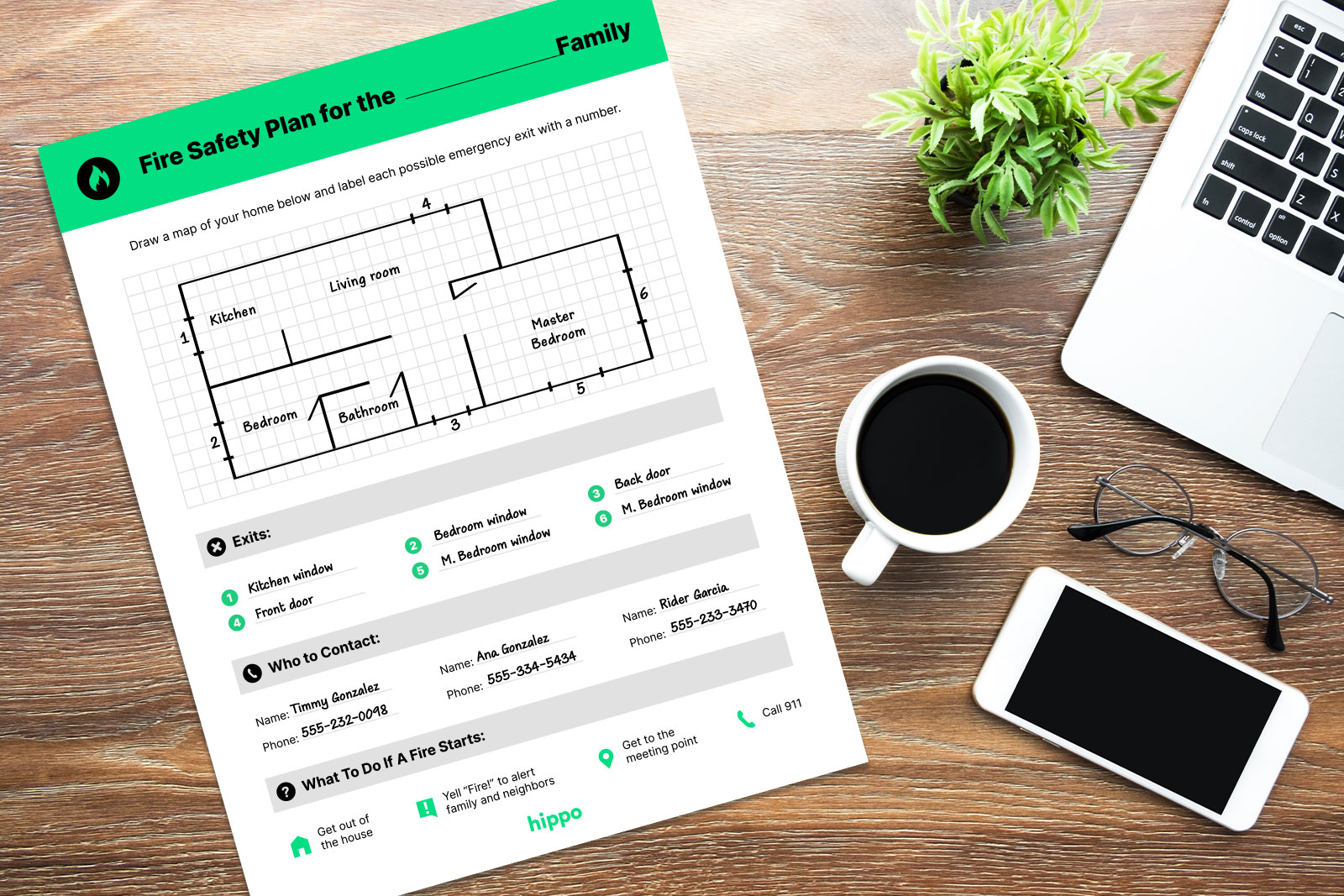 A fire safety planning sheet sits on a wooden desk beside a computer, phone and cup of coffee.