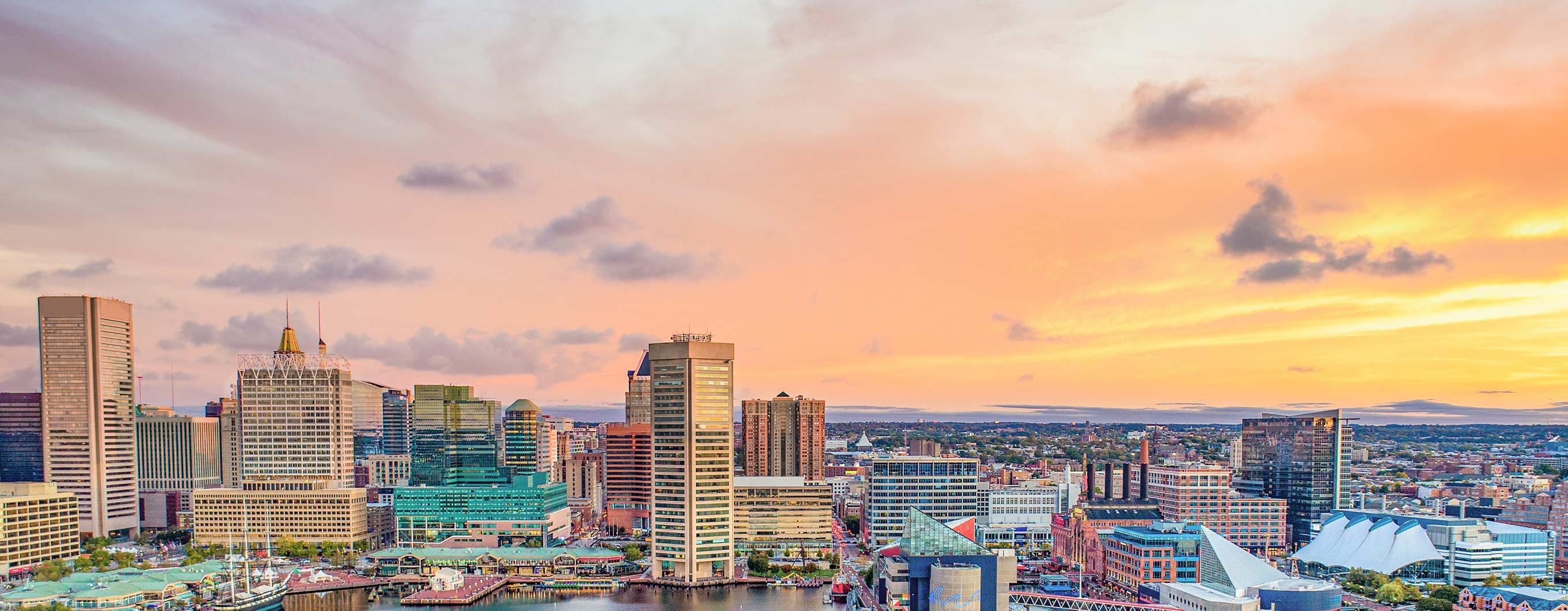 Image of the a skyline with the sun setting behind the buildings