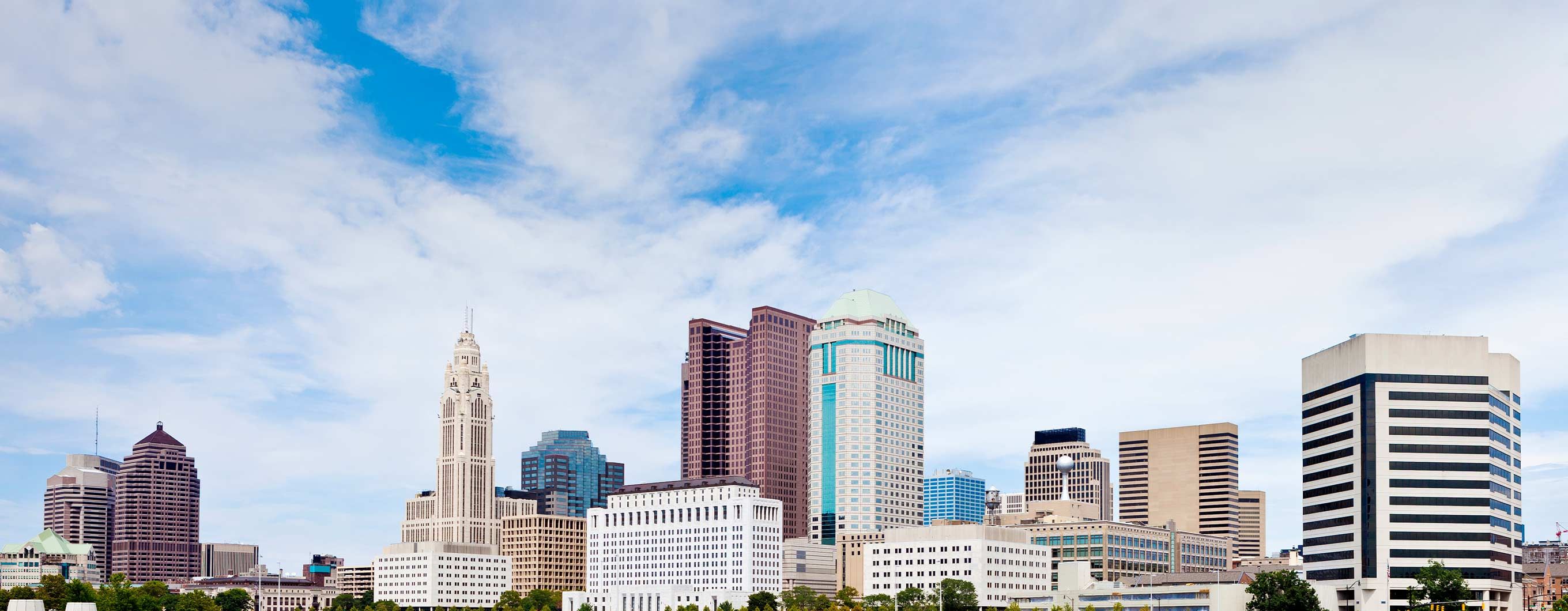 Image of a city skyline with a blue sky behind it