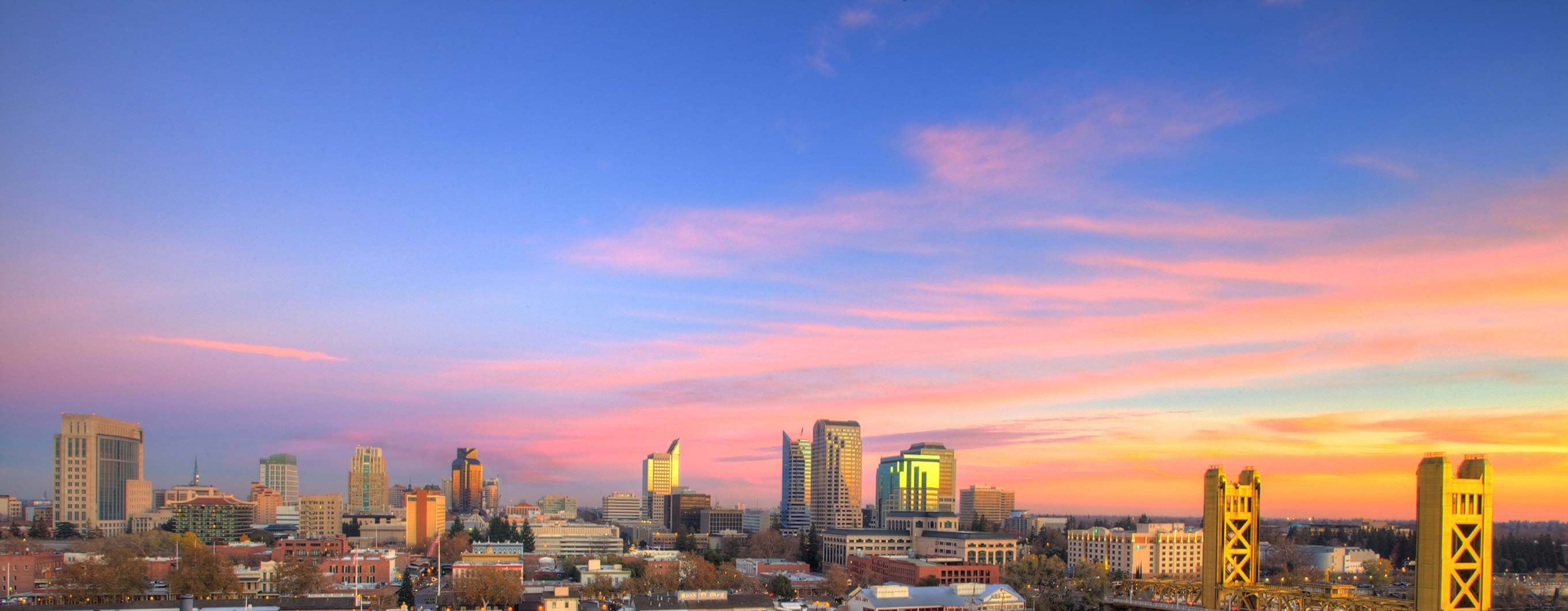 Image of the Sacramento city skyline with a blue and pink sky