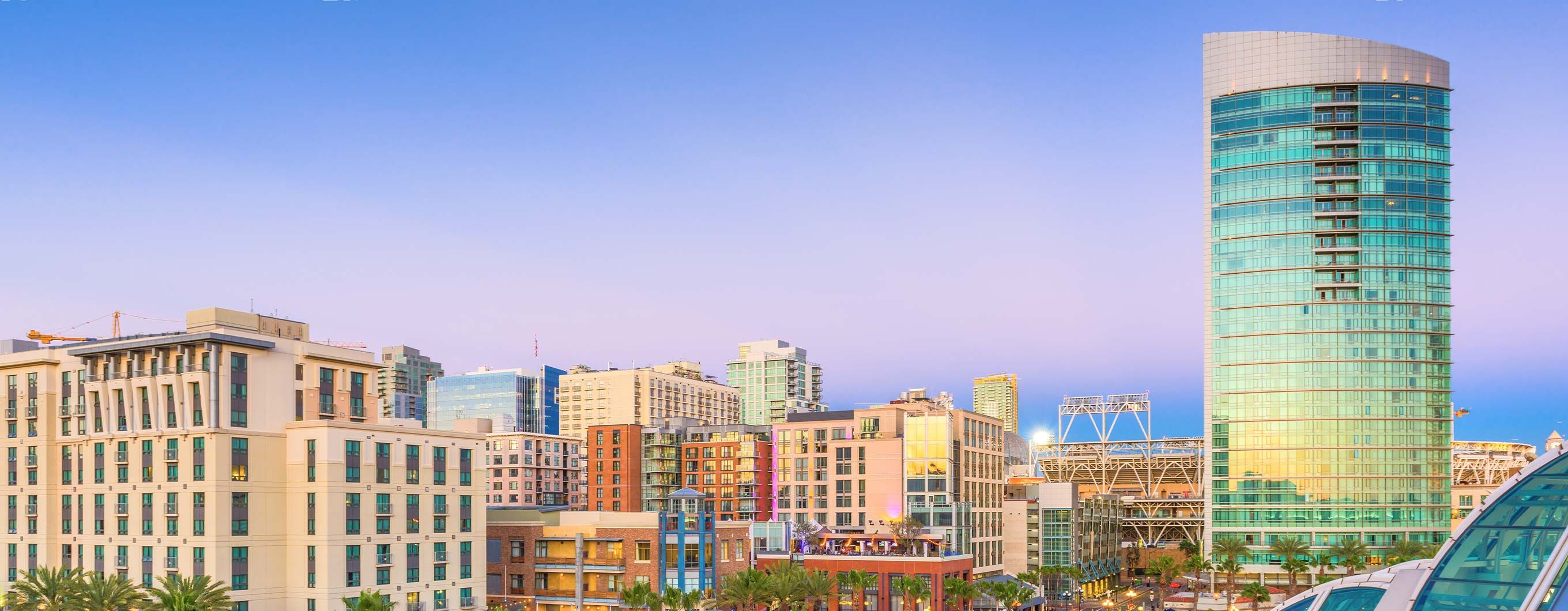 Image of a San Diego city skyline with a blue and purple sky