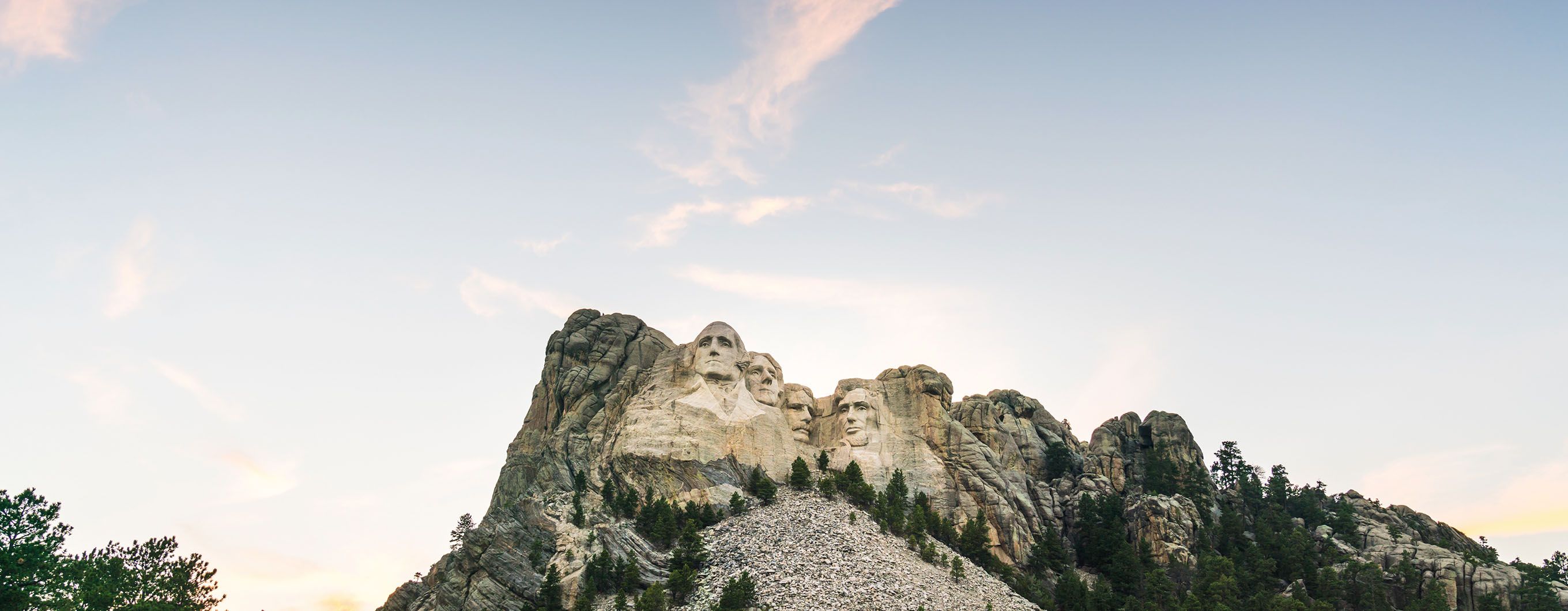 Image of Mount Rushmore with a light blue sky behind it