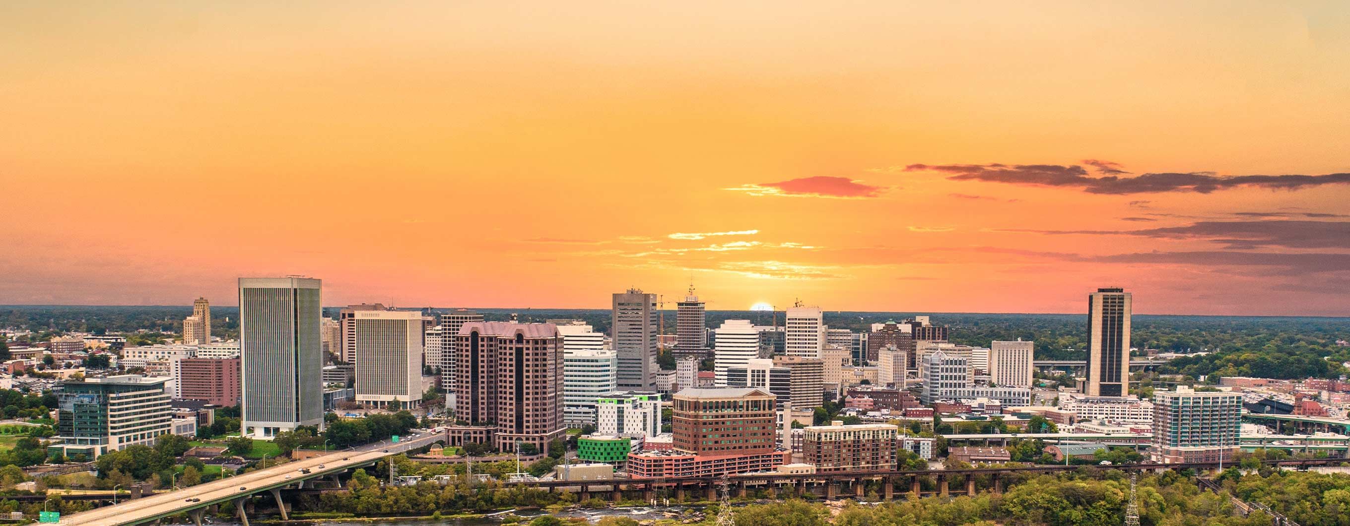 Image of the a skyline with the sun setting behind the buildings