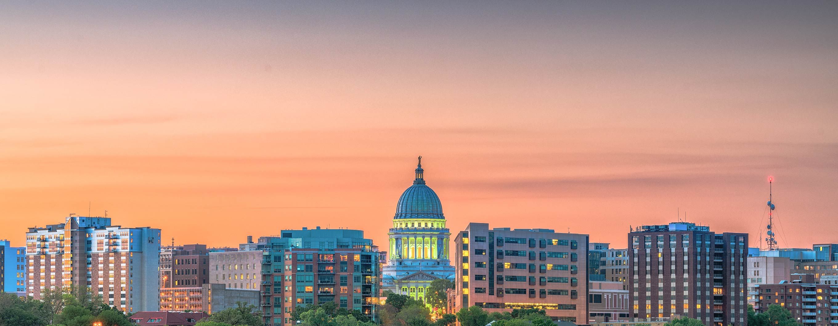 Image of the a city skyline with the sunset behind the buildings