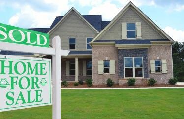 home with a "for sale" sign in the front that was marked sold