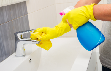 homeowner spring cleaning their bathroom sink