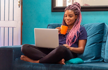 homeowner sitting on the couch and working remotely