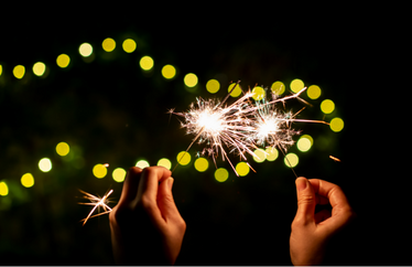 homeowner playing with sparklers near their home in the evening