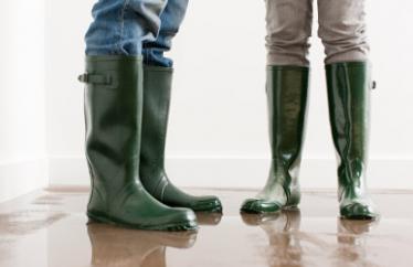 man and woman wearing flood boots