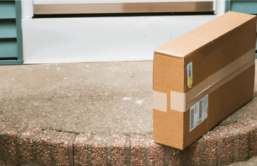 A delivery box left on by the front door of a home